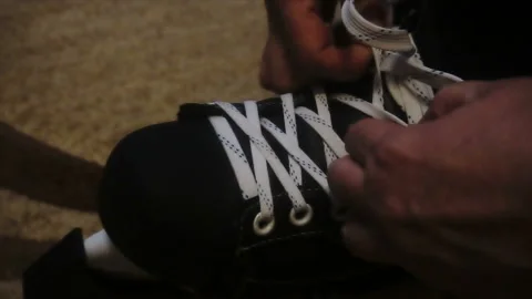 Tying the white laces on skates,preparing to go on the ice Stock Footage 85600081