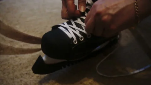 Tying the white laces on skates,preparing to go on the ice 스톡 동영상 85600716
