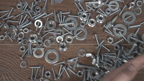 Type of bolts nuts screws on the table close-up hand Video stock 101028570