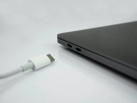 Type C cable and laptop on the white background Stock Photos