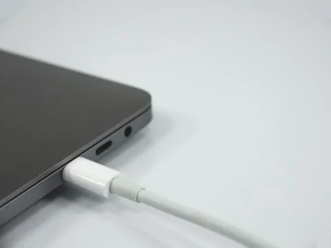 Type C cable and laptop on the white background Stock-Fotos