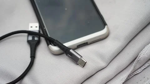 Type C charging cable and a phone with type C port. Foto stock
