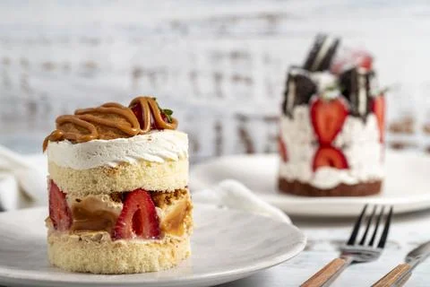 Types of cakes. Fresh cakes with strawberries on a plate. Close up Stock Photos