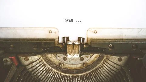 Typewriter and empty white paper with a word Dear, vintage style Fotos de archivo