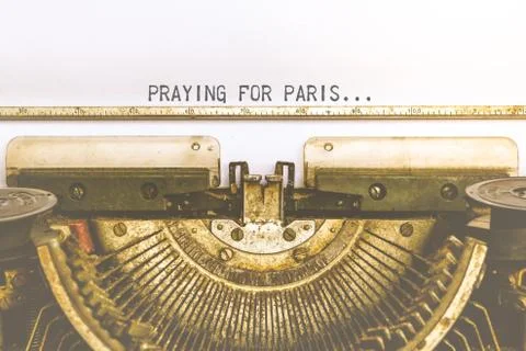 Typewriter and empty white paper with a word Praying For Paris, vintage style 스톡 사진