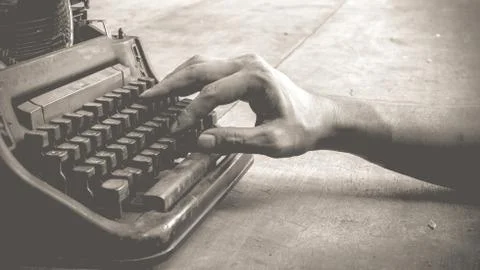 Typewriter and human hand Stock Photos
