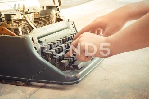 Typewriter and human hand Stock Photos