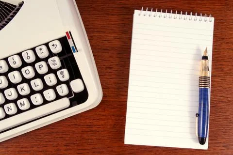 Typewriter and notepad ready for work. Photos