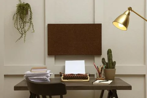 Typewriter and stack of papers on dark table in room. Writer's workplace Foto stock