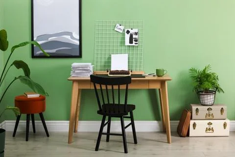 Typewriter, stack of papers and mood board on wooden table near pale green .. 스톡 사진