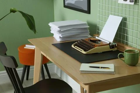 Typewriter, stack of papers and mood board on wooden table near pale green .. 写真素材