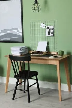 Typewriter, stack of papers and mood board on wooden table near pale green .. 스톡 사진