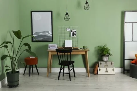 Typewriter, stack of papers and mood board on wooden table near pale green .. Stockfoto's