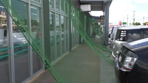 Typhoon net deployed to catch flying debris before striking windows Stock Footage 92421224