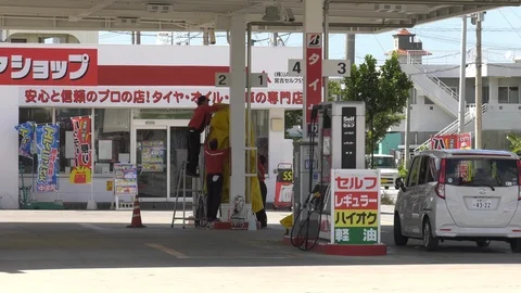 Typhoon preparations - gas station securing pumps Stock Footage 92420068