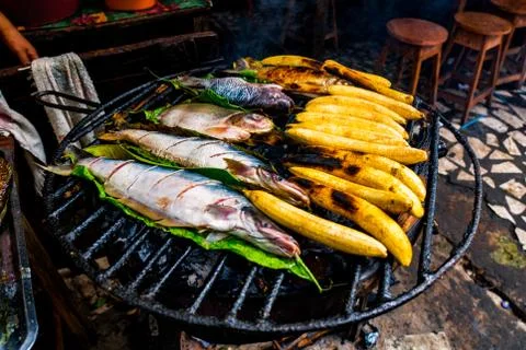 Typical Amazonian lunch made on the grill, with fish and bananas Stock Photos