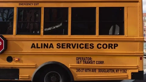 Typical american school bus pulling away on a desolate street Stock Footage 136203747