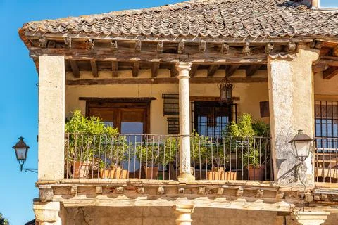 Typical balcony of the medieval town of stonework in stone building with wooden Stock Photos