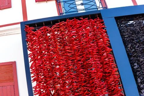 A typical basque frontage with bunches of drying red pappers. Stock Photos