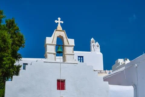 Typical bell tower or small belfry of a whitewashed Greek Orthodox church on a Stock Photos