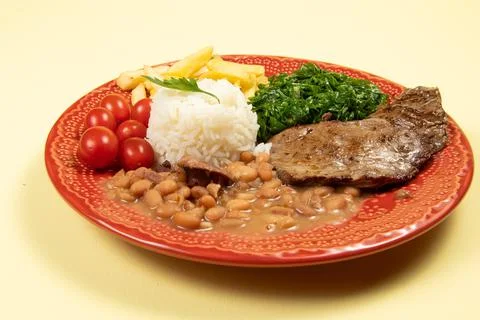 Typical Brazilian basic dish with rice, beans, steak, french fries, braised c Stock Photos