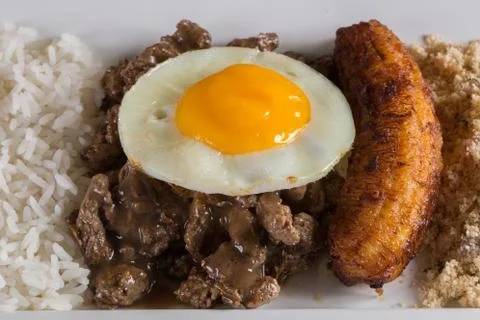 Typical Brazilian dish, diced meat, rice, fried egg and fried banana Stock Photos