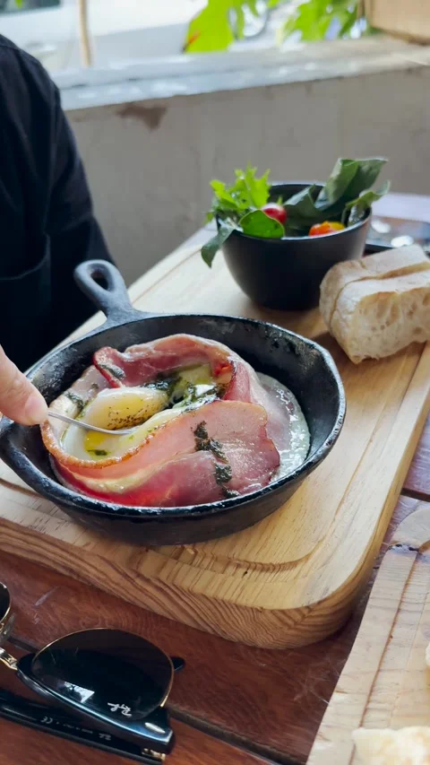 Typical breakfast in mexico, fried eggs with bacon surrounded, bread and salad Stock Footage 249301310