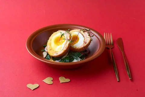 Typical British dish Scotch egg. red background. Stock Photos