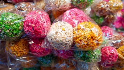 Typical candy in a colorful ball, also called El Alboroto with popcorn and sugar Stock Footage 295390856