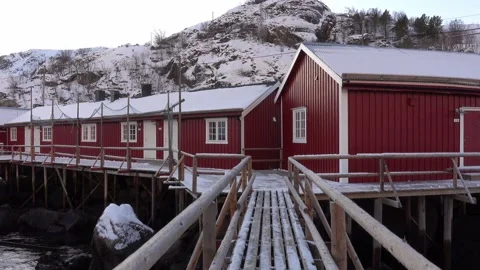 Typical charming village of snowy red cabins in Lofoten, Norway Stock Footage 146237219