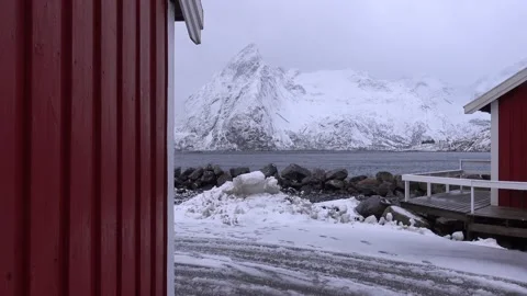 Typical charming village of snowy red cabins in Lofoten, Norway Stock Footage 147468942