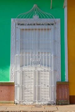 Typical colonial building with white  window iron grate, Cuba Stock Photos