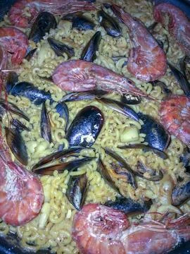Typical dish of the Spanish Mediterranean based on noodles, mussels, prawns.. Stock Photos