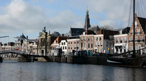 Typical dutch view with canal, bridge, boat, church and houses with big windows Stock Footage 34622298