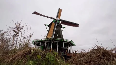 Typical Dutch Windmill of Zaanse Schans spinning in the wind. Video stock 168225444