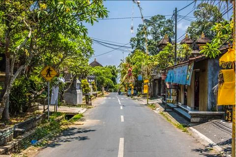 Typical empty road in the daytime in a village in Ubud, Bali, Indonesia Stock Photos