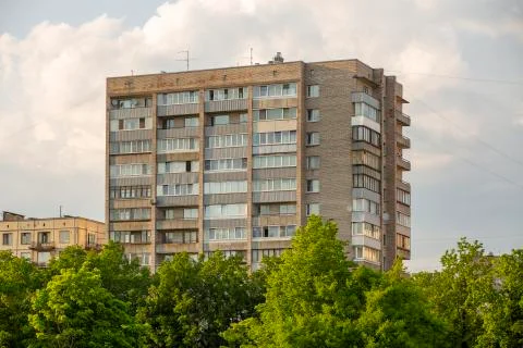 Typical facade of an old brick nine-story building in the post-Soviet countries Stock Photos