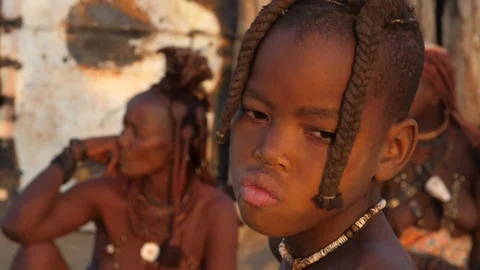 Smiling Himba girl with traditional jewelry