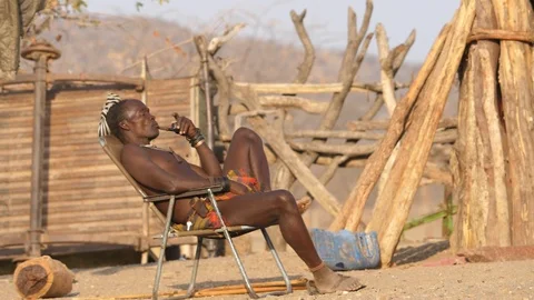 Typical Himba smoking, Kaokoland, Namibia, Africa in HD slowmotion Stock Footage 90854241