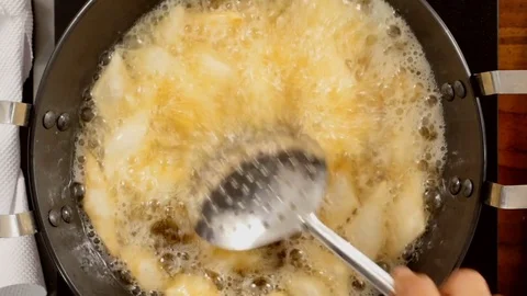 Typical Indian Snack deep Frying on a pan - Closeup Shot Stock Footage 82819273