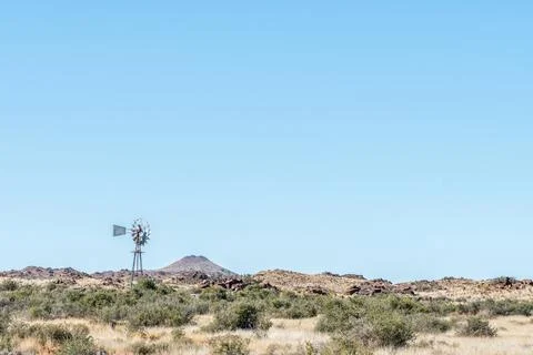 Typical Karoo landscape with a windmill and hills Stock Photos
