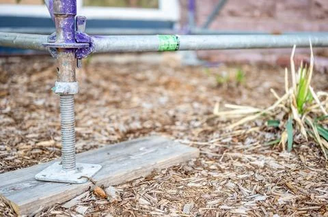 Typical leveling support block as the baseplate of an erected scaffold. Stock Photos