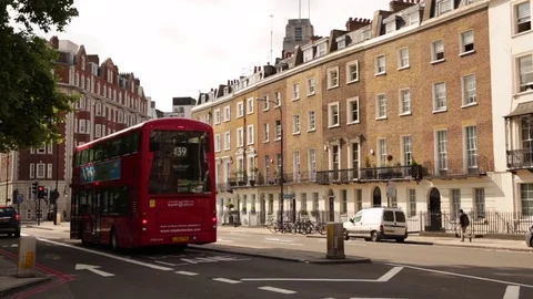 Typical London: red bus and traditional houses Stock Footage