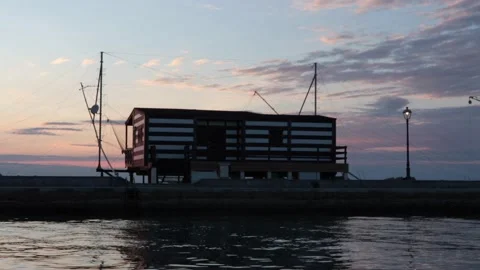 Typical marine construction in the sunset with people Video stock 132048997