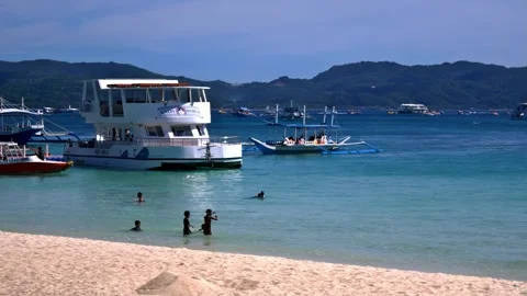 Typical midday scene at Boracay beach, in the Philippines, featuring bathers Stock Footage 345176024