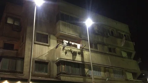A typical Middle Eastern apartment building nx nightime establishing shot in Vidéo 78193258