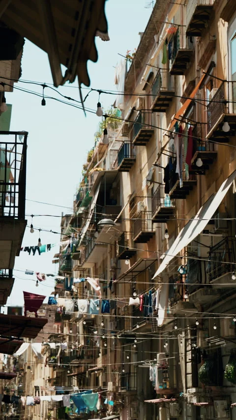 A typical Naples street with laundry hanging on lines strung between buildings Stock Footage 341566996