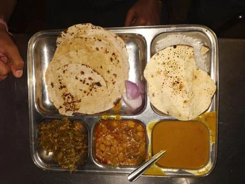 A typical north Indian rectangular thali consisting of multiple bowls. Stock Photos