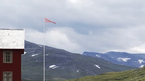 Typical Norwegian view with a rad house and Norwegian flag Stock Footage 118833334