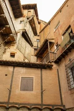 Typical orange-colored adobe and wood facades in the medieval village of Al.. Stock Photos